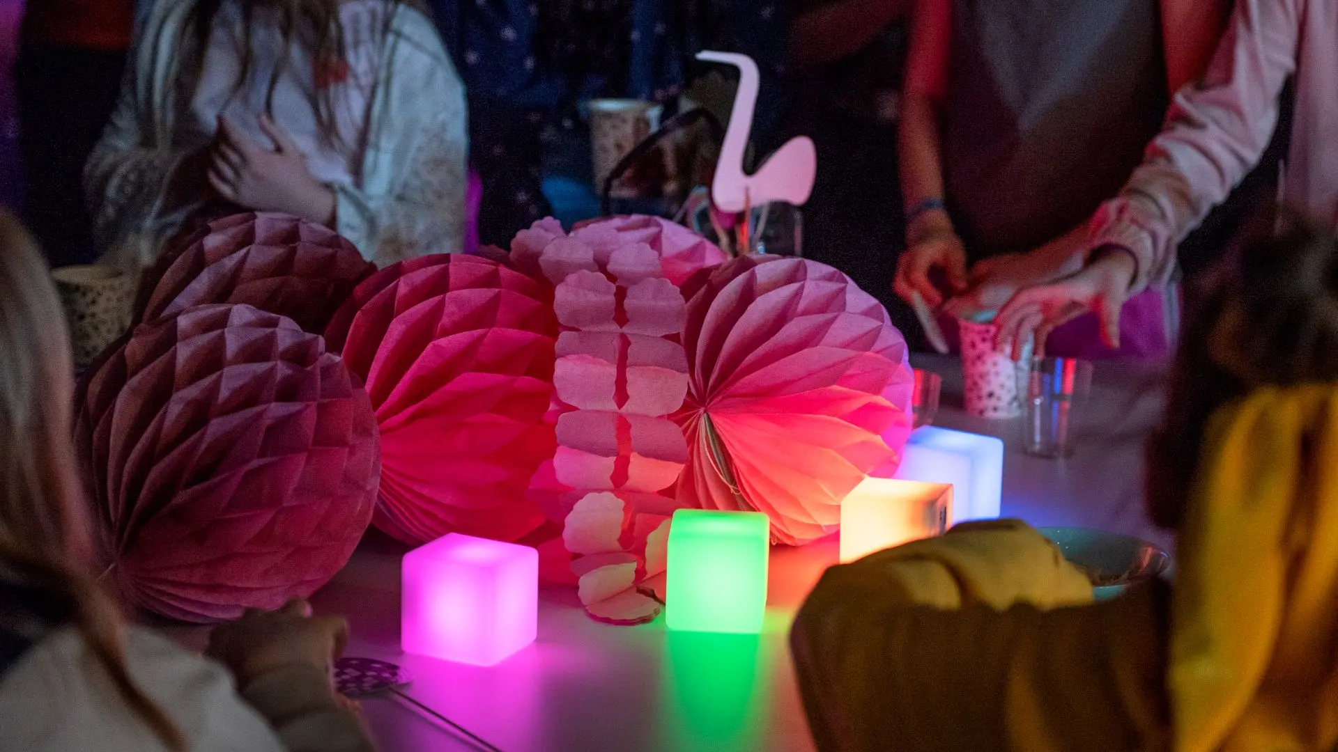 Bild på dukat bord med ljuskuber, rosa honeycombs och en flamingo