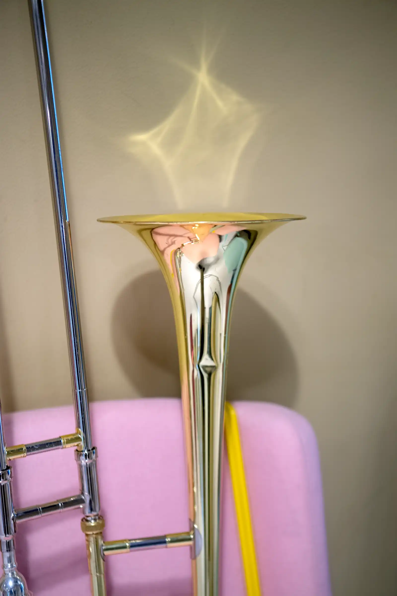 bild på trombon som står på en rosa fåtölj